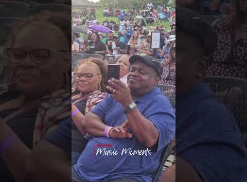 Fans join Rome on stage at a concert, captured by The Community Voice (KS)