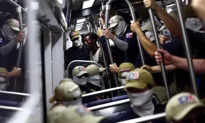 WASHINGTON, DC – JULY 04: A passenger (C) looks on as members of the white supremacist group Patriot Front ride the Washington Metro on July 04, 2026 in Washington, DC. Numerous events, activities, and fireworks are planned in celebration of America’s 250th Anniversary. (Photo by Finn Gomez/Getty Images)