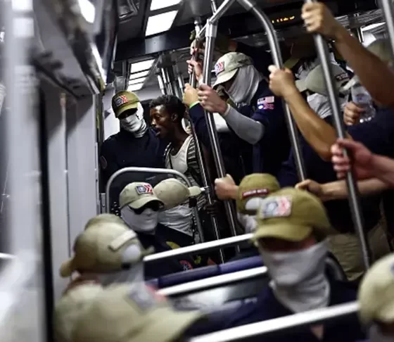 WASHINGTON, DC – JULY 04: A passenger (C) looks on as members of the white supremacist group Patriot Front ride the Washington Metro on July 04, 2026 in Washington, DC. Numerous events, activities, and fireworks are planned in celebration of America’s 250th Anniversary. (Photo by Finn Gomez/Getty Images)