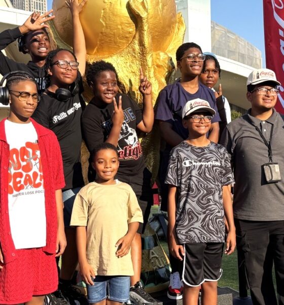 Tour participants stand in front of the Coca-Cola building in Atlanta, Ga