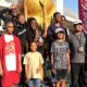 Tour participants stand in front of the Coca-Cola building in Atlanta, Ga