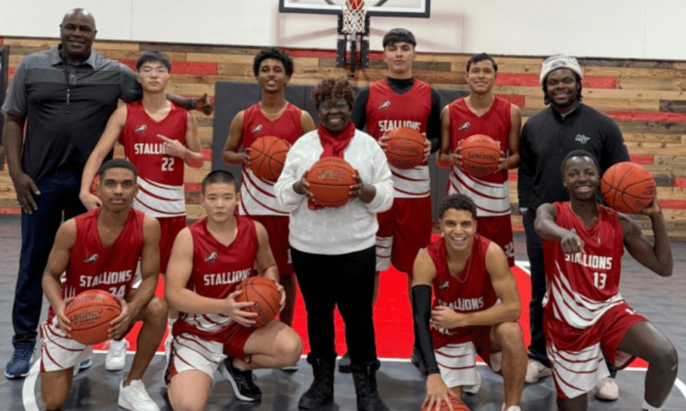 Susie Brooks, center, with Veritas Academy boys basketball players.