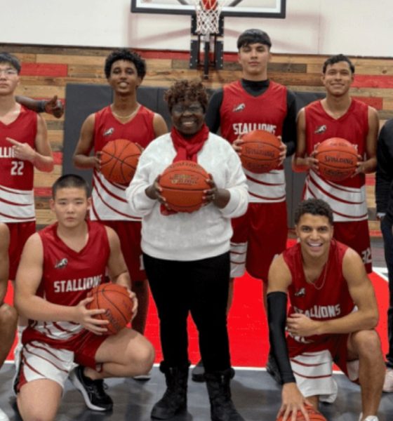 Susie Brooks, center, with Veritas Academy boys basketball players.