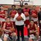 Susie Brooks, center, with Veritas Academy boys basketball players.