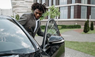 Man entering car with open car door.
