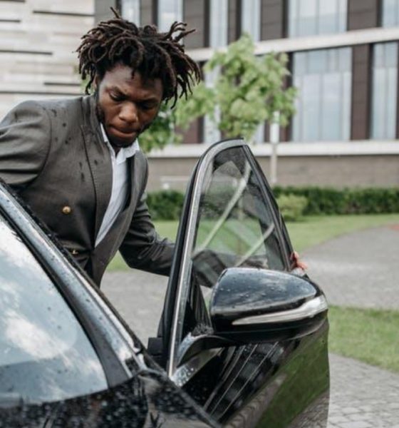 Man entering car with open car door.