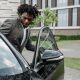 Man entering car with open car door.
