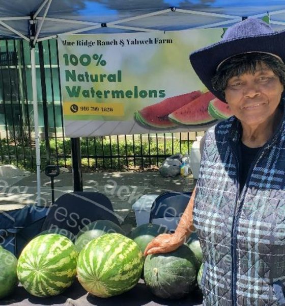 Agricultural Engineer Effie Gant displays watermelons from her Sacramento farm at the Temescal Festival in Oakland. Photo by Carla Thomas.