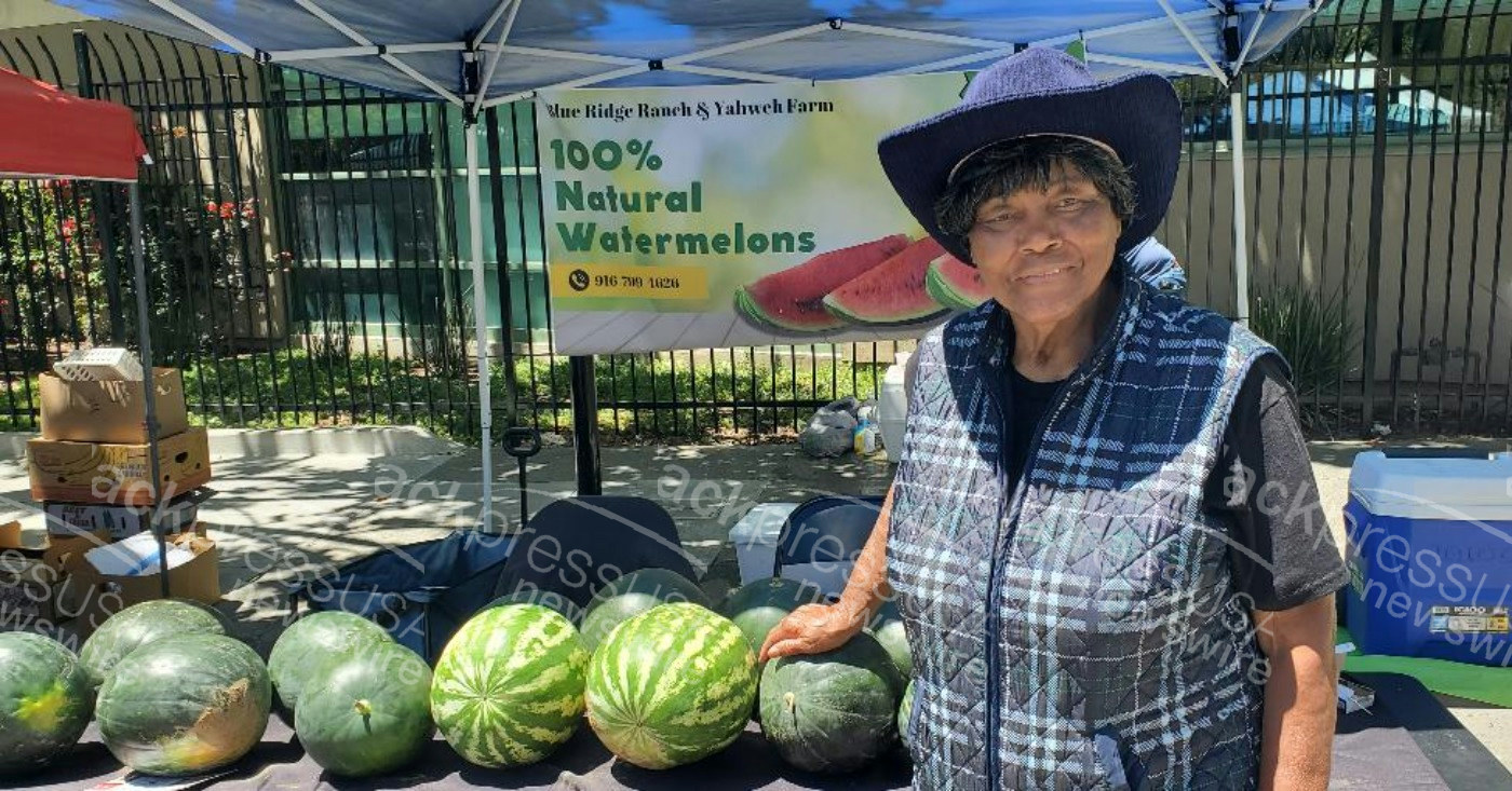 Agricultural Engineer Effie Gant displays watermelons from her Sacramento farm at the Temescal Festival in Oakland. Photo by Carla Thomas.