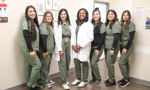 Dr. Ololade Oladimeji and her team pose at Peridot Health Medical clinic in McFarland, which Oladimeji opened just a year ago. "Patients are grateful to have us here."