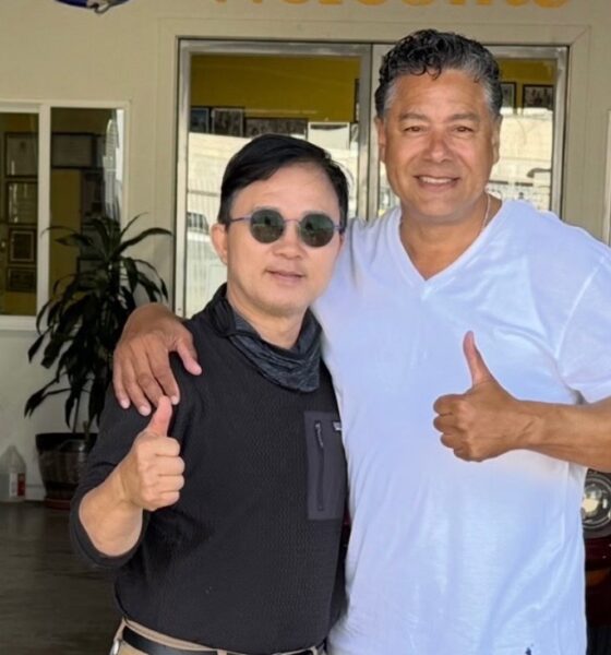 Enoch Shin, left, operator of an auto body shop on International Boulevard in Oakland, with City Councilmember Ken Houston, right, at the Oakland City Council meeting on Tuesday.