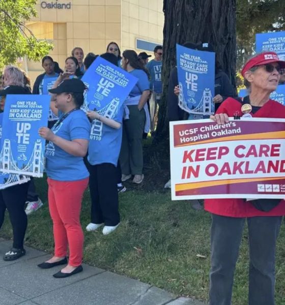 Staff and family members of patients at UCSF Benioff Children's Hospital Oakland in Oakland, Calif., hold signs during a rally on Thursday, July 9, 2026. Rally participants protested the relocation of specialized care clinics to the hospital's San Francisco campus. Photo by Kayla Chan/Bay City News.