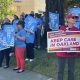 Staff and family members of patients at UCSF Benioff Children's Hospital Oakland in Oakland, Calif., hold signs during a rally on Thursday, July 9, 2026. Rally participants protested the relocation of specialized care clinics to the hospital's San Francisco campus. Photo by Kayla Chan/Bay City News.