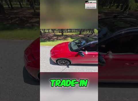 Man locking car door with price tag on it - car buying secret revealed