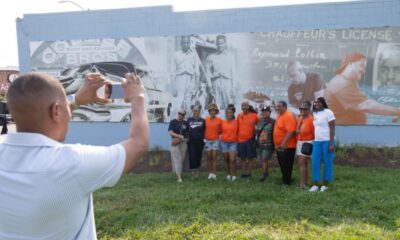 Larry Smith takes a photo during the Common Ground Community Car Show & Block Party celebrating 80 years of Collier Brothers Auto Body and the unveiling of a mural honoring the historic Black owned St. Louis business at 4561 Delmar Blvd. Lawrence Bryant | St. Louis American