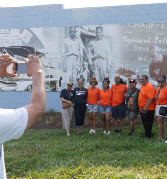 Larry Smith takes a photo during the Common Ground Community Car Show & Block Party celebrating 80 years of Collier Brothers Auto Body and the unveiling of a mural honoring the historic Black owned St. Louis business at 4561 Delmar Blvd. Lawrence Bryant | St. Louis American