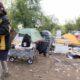 Aug 5, 2026, Saint Paul – A resident of the Pigs Eye encampment carries items out of it. Credit: Chris Juhn