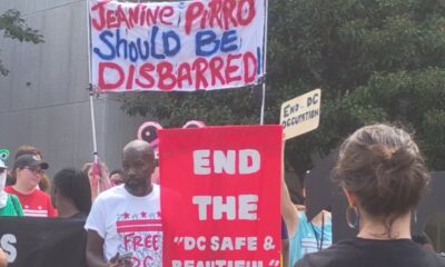 Jerome Hinkle counts among those who stood outside of D.C. Superior Court with signs in hand against U.S. Attorney for the District of Columbia Jeanine Pirro. (Sam Plo Kwia Collins Jr./The Washington Informer)