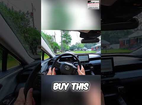 Toyota RAV4 Hybrid driving smoothly on a rough road, showcasing its suspension capabilities.