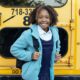 happy ethnic schoolchild near bus on city roadPhoto by Mary Taylor on Pexels.com
