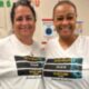 Pictures are Pine Forest School of the Arts teachers Laura Hammock, left, and Tanya Bolden wearing their Jacksonville Free Press "Keep Your Head Up' shirts in support of the Journalism Fund.