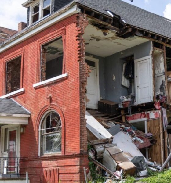 A damaged building on Kensington Avenue remains exposed nearly one year after tornado damage, with part of the structure still open and debris visible inside. Photo by Lawrence Bryant | St. Louis American