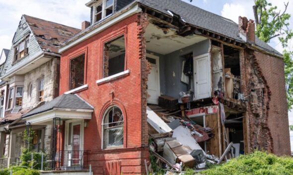 A damaged building on Kensington Avenue remains exposed nearly one year after tornado damage, with part of the structure still open and debris visible inside. Photo by Lawrence Bryant | St. Louis American