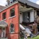 A damaged building on Kensington Avenue remains exposed nearly one year after tornado damage, with part of the structure still open and debris visible inside. Photo by Lawrence Bryant | St. Louis American