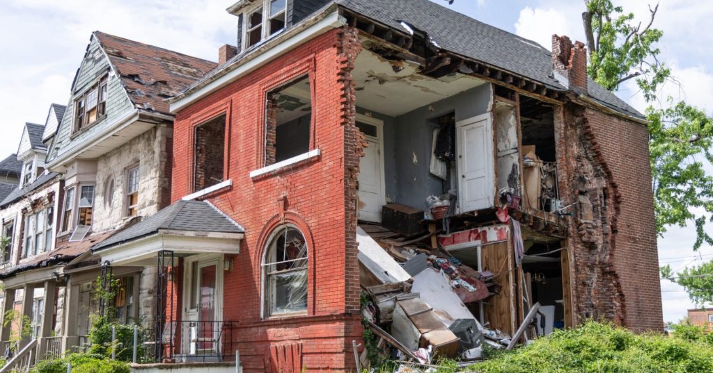 A damaged building on Kensington Avenue remains exposed nearly one year after tornado damage, with part of the structure still open and debris visible inside. Photo by Lawrence Bryant | St. Louis American