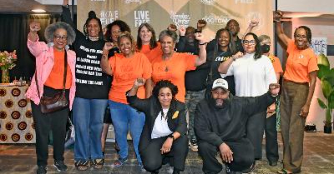 Imani Social Justice Team (left to right): Angela Noel, Zakiya Jendayi and Diane Doss. Patty Hallm, Susan Burns, Diane Lewis, Pastor Michael McBride, Theresa ???, Jean Moses and Diana Bell. Front: Sloane Johnson and (man whose name I'm getting to complete the identification). Photo by Octavian Kelly.