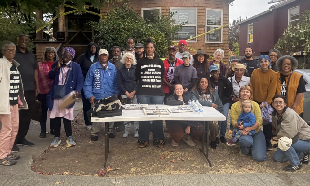 Zakiya Jendayi, center, surrounded by supporters at the weekly gathering at her house to halt her eviction. Photo by Tanya Dennis.