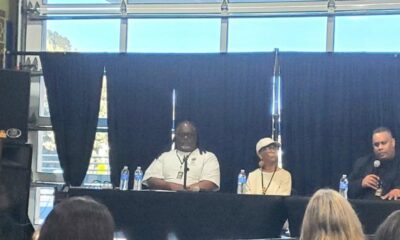 Quixote Atkins of VillageGIVE moderates a panel discussion at the Coliseum 60 celebration at Youth UpRising featuring Keith Brown, a member of IATSE Local 107; author, historian and former Black Panther Party member Tareka Lewis; and African American Sports and Entertainment Group President Ray Bobbitt.