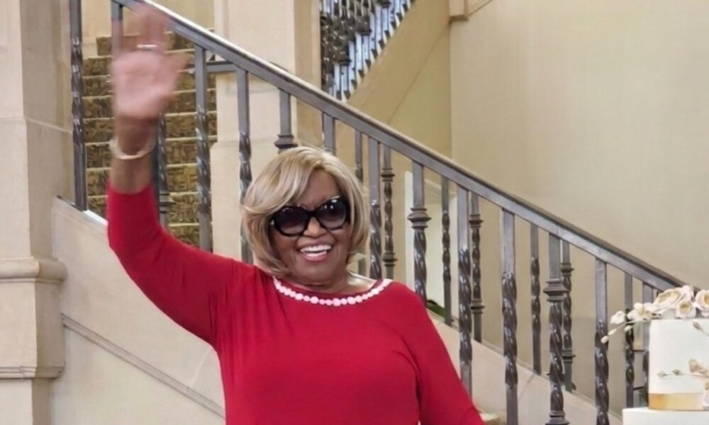 Standing by her birthday cake, Nuna McKee waves to family and friends who came from far and near to celebrate her birthday. Courtesy photo.