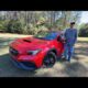 2026 Subaru WRX parked on a scenic road, front view showcasing the modern sports sedan design for a daily driver review.
