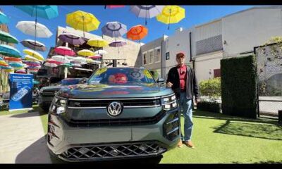 2027 Volkswagen Atlas SEL Premium R Line in front of a modern building, priced at $58,135
