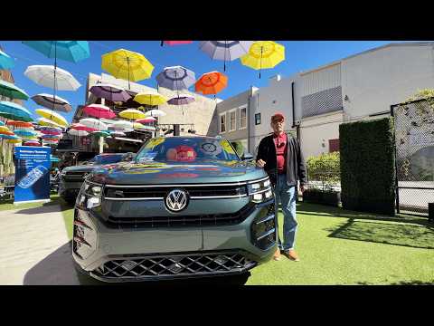 2027 Volkswagen Atlas SEL Premium R Line in front of a modern building, priced at $58,135