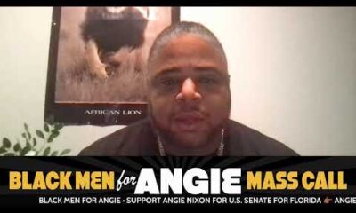 Black men standing together in support of politician Angie Nixon during a community campaign event.