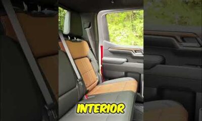 Person sitting in a car interior testing windshield visibility and checking cabin space for an auto buying guide.