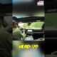 Driver testing a car head-up display on a dashboard to check for glare during daylight driving conditions.