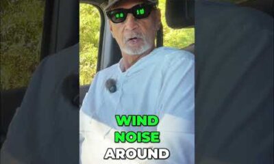 Driver testing vehicle interior cabin comfort and wind noise levels while driving on a highway.