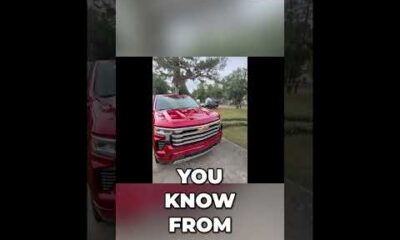 Front view of a rugged Chevy Silverado pickup truck parked outdoors on a bright day for a truck review.