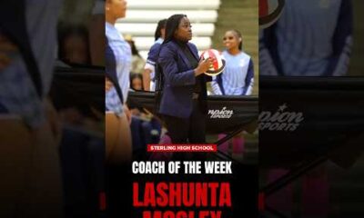 Lashunta Mosley, Houston Defender Coach of the Week, smiling and wearing a branded team polo shirt on a sports field.