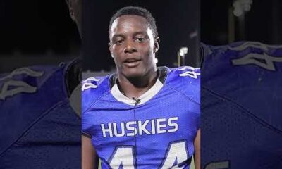 Elijah Eche, a Houston Defender athlete, smiling and looking at the camera during an interview.