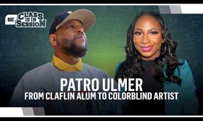 ColorBlind artist and Claflin University graduate showcasing vibrant abstract paintings in a professional studio.