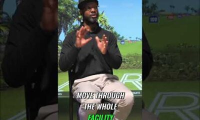 Person learning to golf on a lush green course with a friendly instructor, bright sunny day, outdoor golf setting.