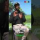 Person learning to golf on a lush green course with a friendly instructor, bright sunny day, outdoor golf setting.