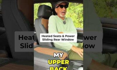 Close-up of a modern truck interior showing heated seat controls and a sliding rear window button for enhanced comfort.
