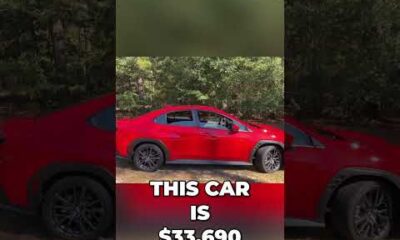 Review of a $34,000 manual transmission turbo sedan parked outdoors for an automotive YouTube channel.