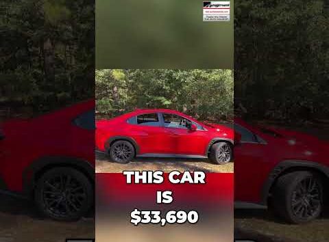 Review of a $34,000 manual transmission turbo sedan parked outdoors for an automotive YouTube channel.