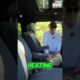 Interior of a luxury SUV featuring plush leather captain's chairs and heated seat controls in a modern vehicle cabin.